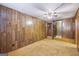 Bedroom with paneled walls, carpeted flooring, ceiling fan, and a small closet at 94 Gilley Rd, Carrollton, GA 30116