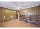 Spacious bedroom featuring wood paneling, ceiling fan, storage shelves, and laminate flooring, providing a versatile layout at 94 Gilley Rd, Carrollton, GA 30116