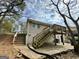 Backyard with stairs leading up to a wooden deck, patio and shady trees at 1145 Penn Se Ct, Atlanta, GA 30315