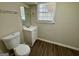 Bathroom features a white vanity, mirror, window and toilet at 1145 Penn Se Ct, Atlanta, GA 30315