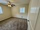 Bedroom features neutral walls, ceiling fan and a window letting in natural light at 1145 Penn Se Ct, Atlanta, GA 30315