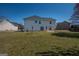 Spacious backyard view of this two-story home features sliding doors to access a concrete patio at 5120 Redcoat Ln, Mcdonough, GA 30252