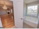 Bright bathroom featuring a tub with tiled surround and a view from the window at 5120 Redcoat Ln, Mcdonough, GA 30252