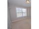 Empty bedroom with carpet flooring and a window providing natural light at 5120 Redcoat Ln, Mcdonough, GA 30252