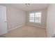 This bedroom has neutral walls, a window, and carpeted floors at 5120 Redcoat Ln, Mcdonough, GA 30252