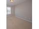 Empty bedroom with carpet flooring and a window providing natural light at 5120 Redcoat Ln, Mcdonough, GA 30252