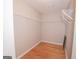 Walk-in closet with installed wire shelving and hardwood floors at 5120 Redcoat Ln, Mcdonough, GA 30252