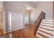 Bright foyer features hardwood floors, a soaring ceiling, and an elegant staircase with iron balusters at 5120 Redcoat Ln, Mcdonough, GA 30252