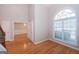 Bright foyer featuring hardwood floors, an arched window, and neutral paint palette at 5120 Redcoat Ln, Mcdonough, GA 30252