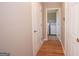 Hallway with hardwood floors leading to a laundry area with a washer and dryer at 5120 Redcoat Ln, Mcdonough, GA 30252