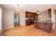 Open kitchen and dining area with hardwood floors and stylish lighting at 5120 Redcoat Ln, Mcdonough, GA 30252
