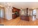 Spacious eat-in kitchen with stainless appliances and center island, flows to living room at 5120 Redcoat Ln, Mcdonough, GA 30252