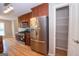 Kitchen boasts stainless appliances, wood cabinets, and a walk-in pantry with wire shelving at 5120 Redcoat Ln, Mcdonough, GA 30252