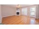 Cozy living room with a fireplace, neutral paint, and a door to the exterior at 5120 Redcoat Ln, Mcdonough, GA 30252