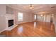 Open concept living area featuring beautiful hardwood floors and a fireplace at 5120 Redcoat Ln, Mcdonough, GA 30252