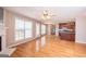 Bright living room featuring hardwood floors, fireplace, and views into the kitchen at 5120 Redcoat Ln, Mcdonough, GA 30252