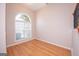 Cozy living room showcasing a large window, gleaming hardwood floors, and neutral paint at 5120 Redcoat Ln, Mcdonough, GA 30252