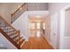 Hardwood staircase with iron railings in the foyer, leading to the second floor at 5120 Redcoat Ln, Mcdonough, GA 30252