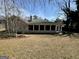 Rear exterior view of home with screened in porch and yard at 5319 Orly Ter, South Fulton, GA 30349