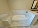 Bathroom featuring a soaking tub with tiled surround and marble accents at 5319 Orly Ter, South Fulton, GA 30349