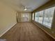 Carpeted living room with ceiling fan, bright light and access to patio at 5319 Orly Ter, South Fulton, GA 30349