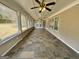 Enclosed sunroom with tile floor and multiple ceiling fans at 5319 Orly Ter, South Fulton, GA 30349