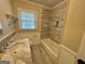 Bathroom featuring tiled shower and bathtub, marble vanity, and updated fixtures for a modern feel at 230 Argus Cir, Atlanta, GA 30331