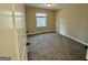 Cozy carpeted bedroom featuring a window for natural light and neutral walls at 230 Argus Cir, Atlanta, GA 30331