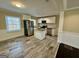 Modern kitchen with stainless steel appliances, a granite-top island, and wood-look flooring at 230 Argus Cir, Atlanta, GA 30331
