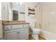 Well-lit bathroom with a granite countertop vanity and shower/tub combo at 485 County Line W Rd, Covington, GA 30016