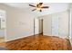 Bedroom featuring hardwood floors, ceiling fan, and an adjacent bathroom at 485 County Line W Rd, Covington, GA 30016