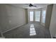 This bedroom has a ceiling fan and three large windows at 1006 Harbor View Ln, Mcdonough, GA 30252