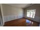 Dining room featuring hardwood floors, decorative paneling, and bright windows at 1006 Harbor View Ln, Mcdonough, GA 30252