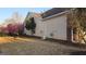 Exterior of the home with side yard and blossoming trees, offering a touch of nature at 1006 Harbor View Ln, Mcdonough, GA 30252