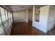 Open living room featuring hardwood floors and natural light from large windows at 1006 Harbor View Ln, Mcdonough, GA 30252