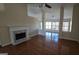 Spacious living area offering a fireplace, vaulted ceiling, and hardwood floors, creating a bright and airy ambiance at 1006 Harbor View Ln, Mcdonough, GA 30252