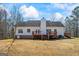 Back exterior of home with a deck, patio, and wooded surroundings at 1191 Rawlings Dr, Rutledge, GA 30663