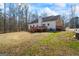 Home featuring a deck and a spacious backyard surrounded by trees at 1191 Rawlings Dr, Rutledge, GA 30663