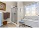 Bright bathroom featuring a glass enclosed shower and decorative leaded glass window at 1191 Rawlings Dr, Rutledge, GA 30663