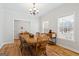 Dining area featuring wood floors, bright walls, and windows with blinds for privacy at 1191 Rawlings Dr, Rutledge, GA 30663