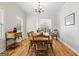 Cozy dining area with hardwood floors, natural lighting, and classic chandelier at 1191 Rawlings Dr, Rutledge, GA 30663