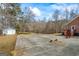 Spacious driveway and view of home with shed on wooded lot at 1191 Rawlings Dr, Rutledge, GA 30663