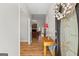 Bright foyer with light walls, wood floors, and a view to living room with fireplace at 1191 Rawlings Dr, Rutledge, GA 30663