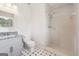 Bright bathroom with granite vanity, tiled shower, and black and white floors at 131 Heron Dr, Riverdale, GA 30274