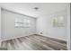 Bedroom featuring sleek wood floors and two windows offering natural light at 131 Heron Dr, Riverdale, GA 30274