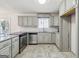 Well-lit kitchen featuring stainless steel appliances, gray cabinetry and stylish countertops at 131 Heron Dr, Riverdale, GA 30274