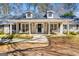 Inviting covered front porch with classic columns and decorative details at 105 Roundleaf Ct, Peachtree City, GA 30269