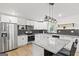 Updated kitchen with granite countertops, stainless steel appliances, and modern lighting at 1077 Peeples Sw St, Atlanta, GA 30310