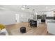 Open layout showcasing kitchen with island and stainless appliances, flowing to living spaces at 1077 Peeples Sw St, Atlanta, GA 30310
