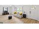 Cozy living room featuring hardwood floors, a comfortable couch, and a dark ottoman at 1077 Peeples Sw St, Atlanta, GA 30310